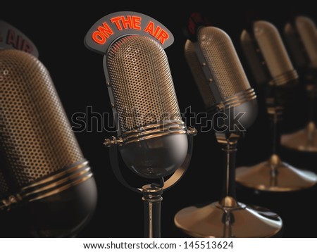 Classic microphone in depth of field over black background.