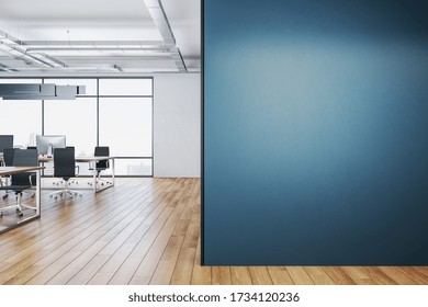 Clean Coworking Office Interior With Equipment On Desktop, City View And Blank Blue Wall.  Workplace And Corporate Concept. 3D Rendering