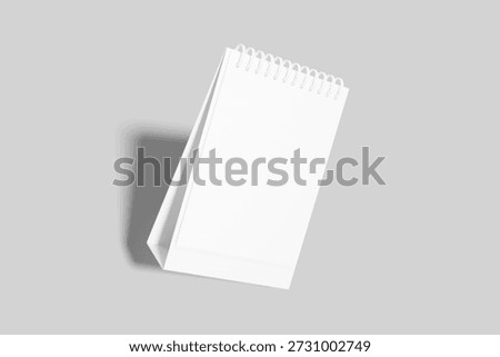 Clean, customizable mockup of an empty white spiral bound desk calendar with a subtle shadow, ready for design presentation