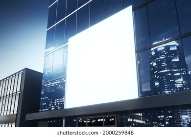 Clean White Billboard On Shiny Glass Building Exterior With Reflections At Night Time. Mock Up, 3D Rendering