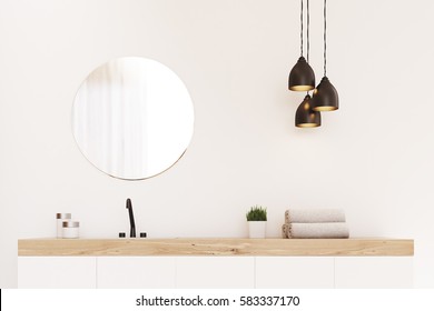 Close Up Of A Bathroom Sink, A Round Mirror And A Towel. There Is A Wooden Decoration Element. Concept Of Modern Luxury Interior. 3d Rendering. Mock Up.