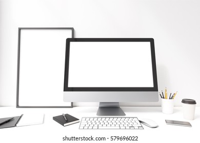 Close up of a blank computer screen standing on a desk near a white wall. There is a framed poster by its side. 3d rendering. Mock up.