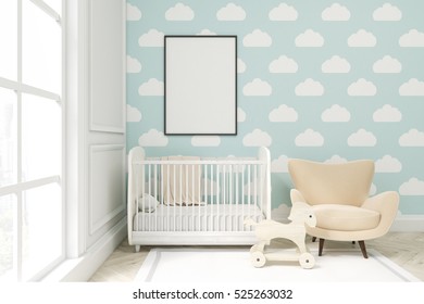 Close Up Of A Child's Room With A Vertical Framed Poster, A Cradle, An Armchair And A Toy Horse. There Is A Large Window And Light Blue Cloud Wallpaper. 3d Rendering. Mock Up