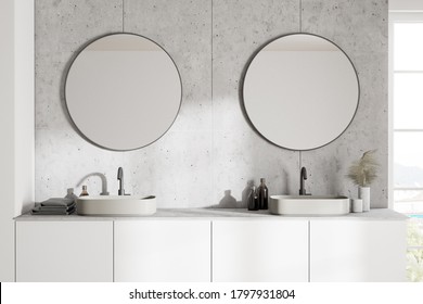 Close Up Of Comfortable Double Sink Standing On White Counter In Modern Bathroom With White And Tiled Walls And Two Round Mirrors. 3d Rendering