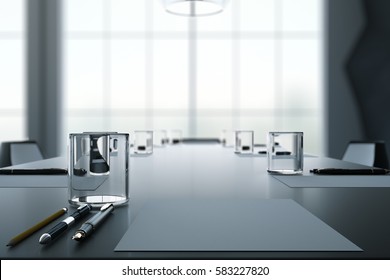 Close Up Of Dark Conference Table With Water Glasses, Pens, Paper Sheets And Blurry Window Background. 3D Rendering