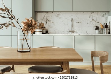 Close up of dinning table in kitchen interior, cabinet with modern kitchenware and sink with stove. Minimalist cooking area with wooden design