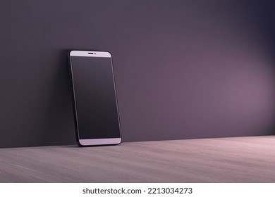 Close up of empty black cellphone on dark wall and wooden surface background. Mobile app concept. 3D Rendering