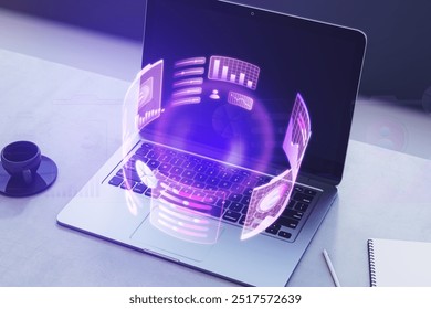 Close up of laptop on desk with coffee cup, supplies and glowing round business graph hologram on dark background. Financial growth, analysis and report concept. 3D Rendering - Powered by Shutterstock