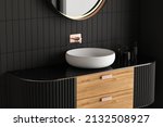Close up of modern black bathroom furniture with white sink and black marble countertop. Side view.3d Rendering