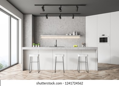 Close Up Of Panoramic Kitchen With Concrete Walls, Wooden Floor, White And Concrete Counters And White Bar With Stools. 3d Rendering