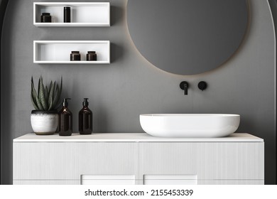 Close up of sink with oval mirror standing in on concrete wall, white cabinet with black faucet in minimalist bathroom. Mock up, stand, front view. 3d rendering
 - Shutterstock ID 2155453339