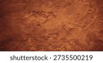 Close up view of a textured reddish brown surface resembling dried mud or aged earth