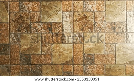 a close up view of a tiled surface. The tiles are arranged in a pattern and have a variety of earthy tones, including shades of brown, beige and tan. The tiles have a textured apperance.