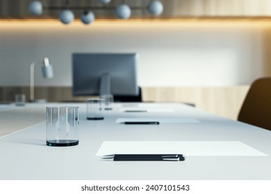 Close up of white table with objects in modern conference room. Blurry interior background. Workplace concept. 3D Rendering