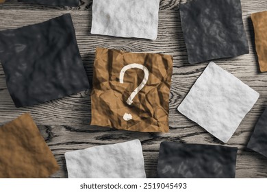 Close up of wrinkled pieces of paper with question mark on wooden desk. Supplies, stationery, school, work and education concept. 3D Rendering - Powered by Shutterstock