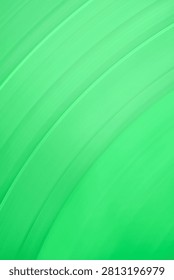 A close-up, abstract background featuring the surface of a bright, fresh green leaf, highlighting the natural, curved parallel lines and smooth texture of its veins