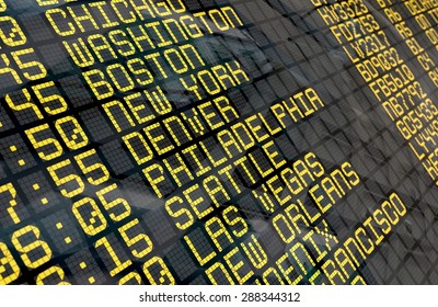 Close-up of an airport departure board to usa cities destinations, with environment reflection.Part of a series.