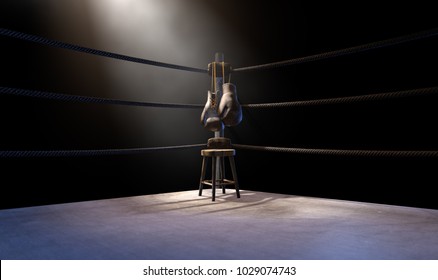 A closeup of the corner of an old vintage boxing ring surrounded by ropes spotlit by a spotlight on an isolated dark background - 3D render