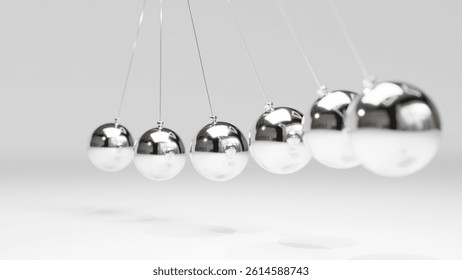 Close-Up of Newton’s Cradle with Shiny Metal Balls on White Background