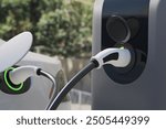 Closeup EV charger handle plugged in or connect to electric car, EV car while charging at chager station sevice, 3d rendering.