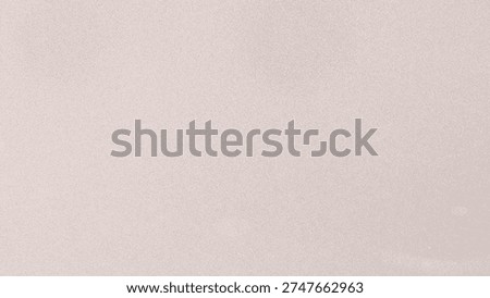 Close-up of a fine-grained textured surface in a delicate pastel pink hue with a hint of sparkle