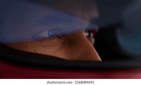 Close-up of a focused pilot driver in a red racing car, wearing a helmet, preparing for a high-speed race. Realistic 3d rendering. 3D Illustration