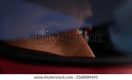 Close-up of a focused pilot driver in a red racing car, wearing a helmet, preparing for a high-speed race. Realistic 3d rendering. 3D Illustration