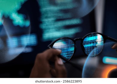 Close-up of glasses reflecting computer code, symbolizing technology and programming. The focus is on digital data and coding, highlighting tech innovation.