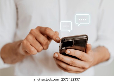 Close-up of hands using a smartphone, typing messages. Communication, texting, and smartphone usage are the focus. Casual attire, digital interaction. Social media sharing and messaging.