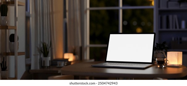 A close-up image of a laptop computer with a white-screen mockup on a table in a room at home at night, illuminated by a table lamp. home workspace, dark workspace, 3d render, 3d illustration