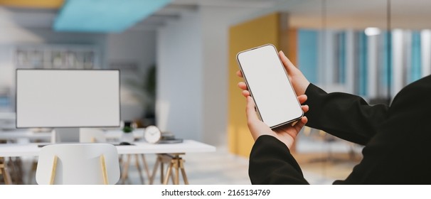 Close-up image, Modern office building workplace interior design with a businesswoman's hands holding a smart mobile phone white screen mockup on the foreground. 3d rendering, 3d illustration - Powered by Shutterstock