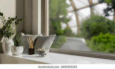 A close-up image of a white window sill or window board featuring a coffee cup, pillows, a reed diffuser, and potted plants in a modern, minimal living room. 3d render, 3d illustration