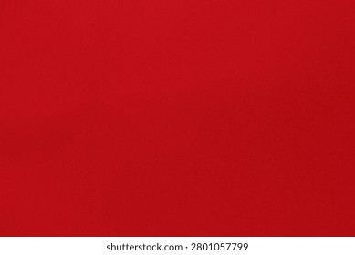 a close-up of a luxurious red fabric with a subtle grain and rich, deep crimson hue, showcasing the intricate texture and soft surface of high-quality textile material, captured in high-resolution detail for commercial use, ideal for interior design, fashion, and luxury product advertising