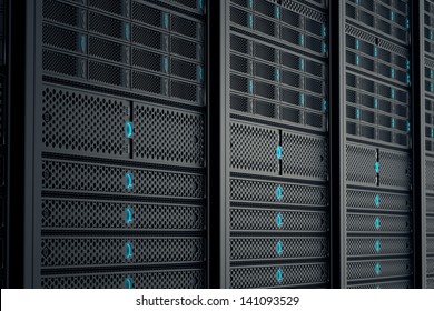 Closeup on data servers while working. Blue LED lights are flashing. Image can represent cloud computing, information storage, etc. or can be the perfect technology background.