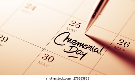 Closeup of a personal agenda setting an important date written with pen. The words Memorial Day written on a white notebook to remind you an important appointment.