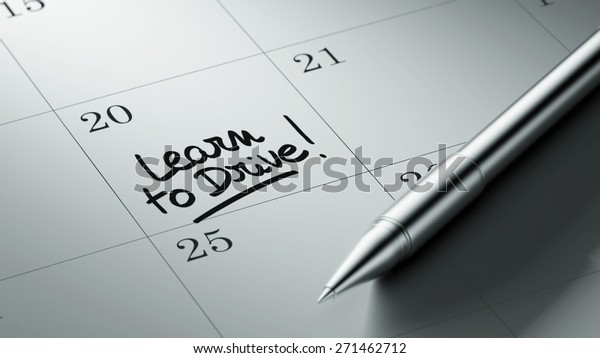 Closeup of a personal agenda\
setting an important date written with pen. The words Learn to\
Drive written on a white notebook to remind you an important\
appointment.