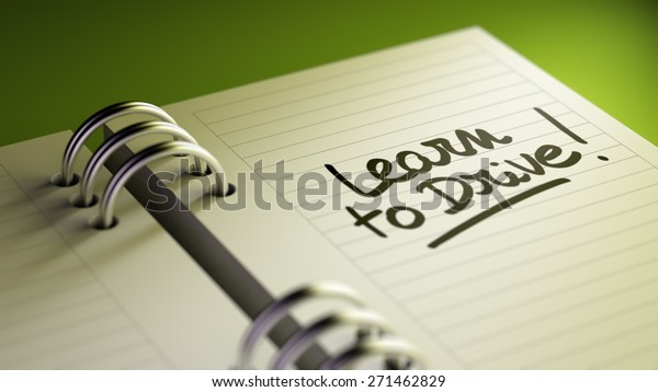 Closeup of a\
personal agenda setting an important date representing a time\
schedule. The words Learn to Drive written on a white notebook to\
remind you an important\
appointment.