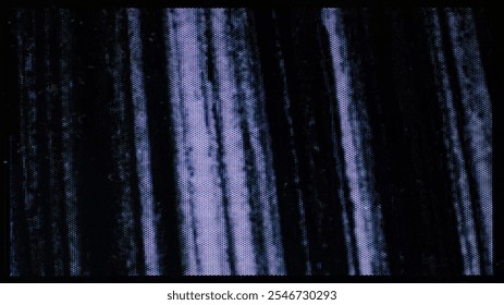 A close-up of the screen texture of an old VHS tape, with a blue color background and a grainy film effect. Photo overlay via blend mode.