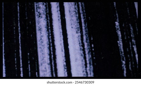 A close-up of the screen texture of an old VHS tape, with a blue color background and a grainy film effect. Photo overlay via blend mode.