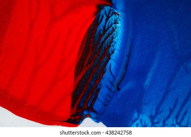 Closeup view of abstract hand painted blue and red acrylic art background on paper texture