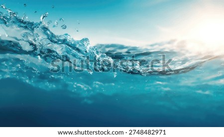 Close-up view of the ocean's surface, showing clear blue water and sunlight reflecting on the waves.