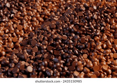 Close-up view showcasing a diverse and plentiful assortment of dark and milk chocolate chips, perfect for culinary creations, desserts, and indulgent snacking.