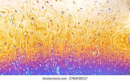 Close-up view of a soap film's interference colors, showcasing swirling patterns and fluid dynamics