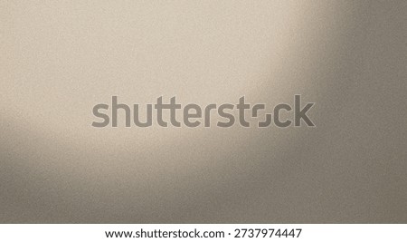 A close-up view of a textured, sandy surface with subtle lighting variations.