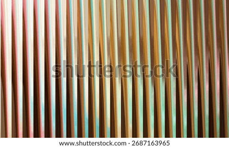 A close-up view of a textured surface displaying distinct vertical lines with a rich palette of warm colors, creating an abstract and visually engaging pattern.