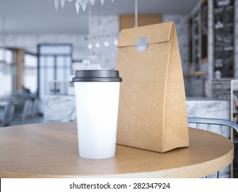 Coffe Cup And Paper Bag On Table. 3d Rendering