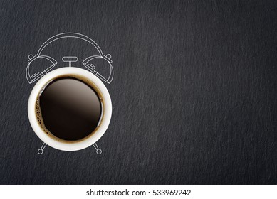 Coffee break concept. Coffee cup and sketch of alarm clock on black slate background. - Powered by Shutterstock