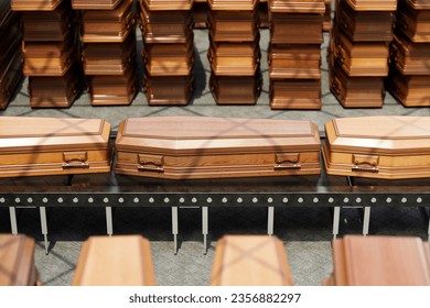 Coffins on a conveyor belt at the airport. The grim scene portrays the transportation of the deceased from one location to another. Funeral, memorial service transport. Wooden coffins stacked. - Powered by Shutterstock