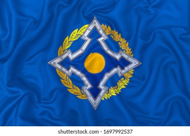 Collective Security Treaty Organization Flag On Wavy Silk Textile Fabric Background.