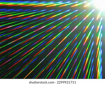Color explosion of white light rays in view through the diffraction grating of an RGB filter.  A rainbow of colors. Rainbow rays. Diffraction images. Prism light. Black background. Abstract image.